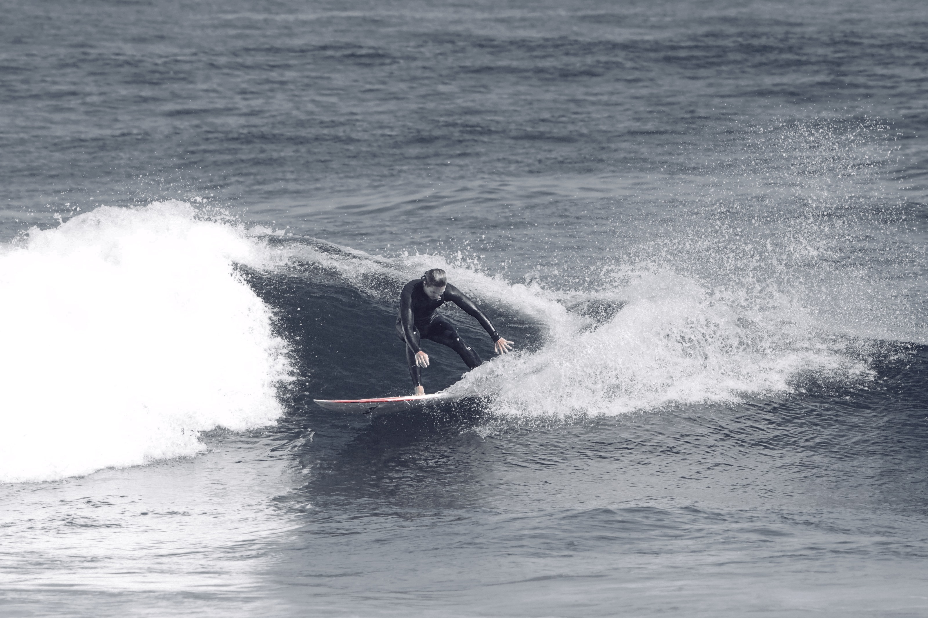 Surf em preto e branco numa onda cinzenta